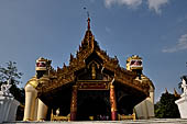 Yangon Myanmar. Shwedagon Pagoda (the Golden Stupa). The southern entrance guarded by two colossal chinthe (half lion, half-dragon guardian figures). 